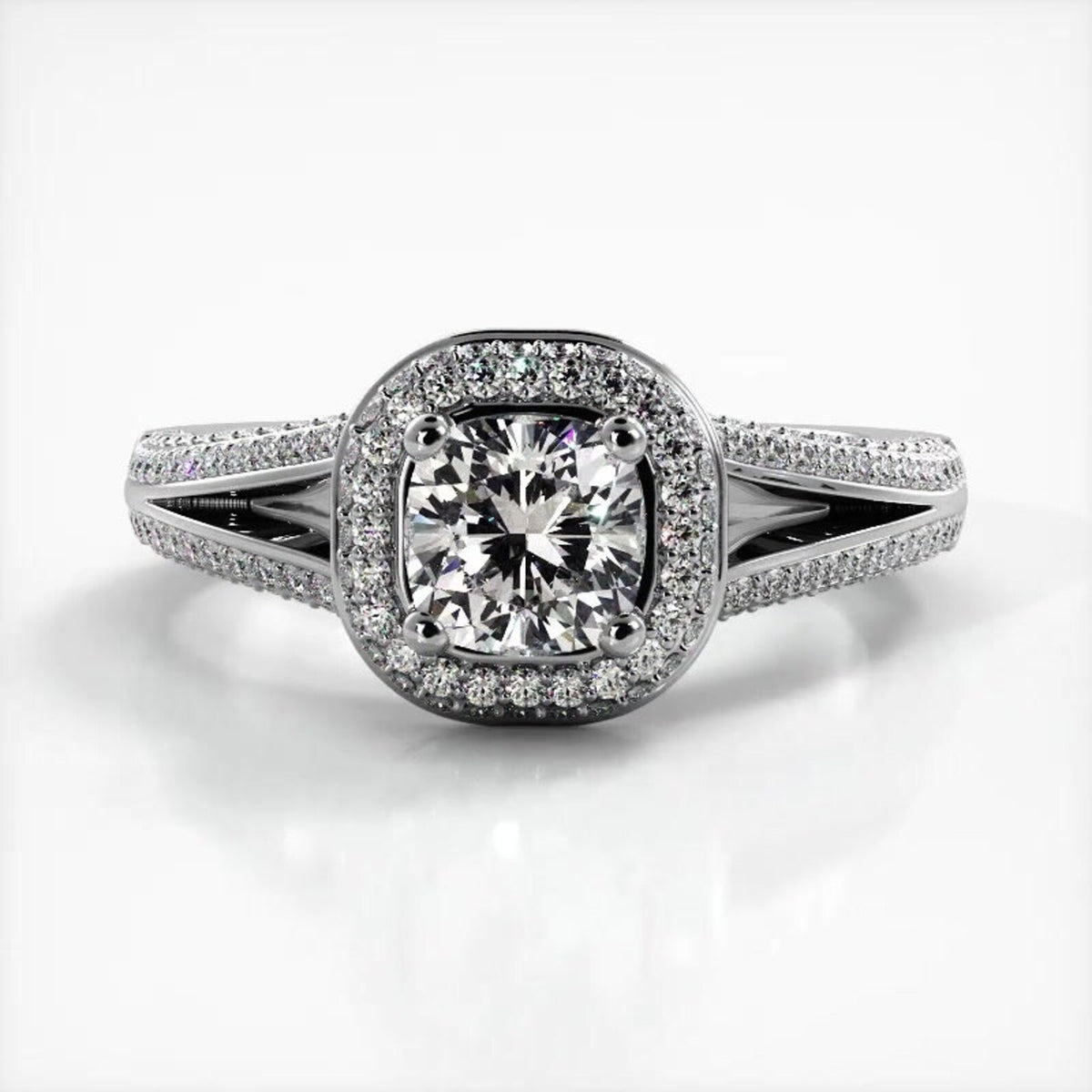 Front view of 2 CT cushion cut lab grown diamond ring with micro-pave halo and split shank band in white gold.