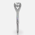 Side profile view of white gold 2 carat round cut lab diamond ring showcasing cathedral basket and pave band details.