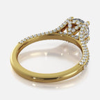 Angled perspective view of yellow gold 2 CT round lab grown diamond ring displaying cathedral shank and pave accents.
