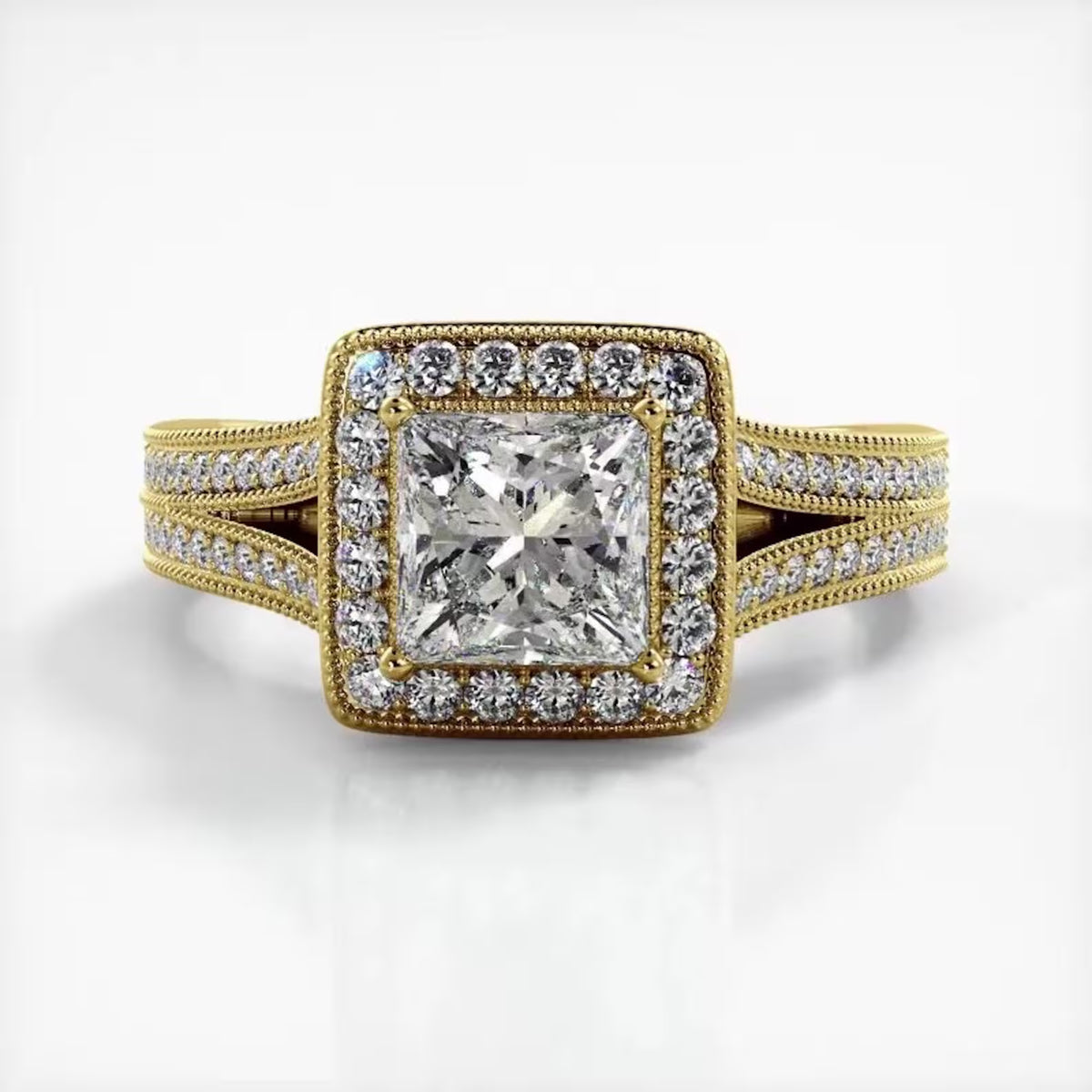 Direct front view of 2 CT princess cut lab diamond halo engagement ring with split shank in yellow gold.