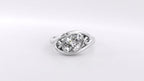 Top-down view of a 2 CT oval lab grown diamond ring with bypass bezel setting and scroll motif in white gold.