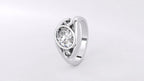 Three-quarter angle showing the high-polish band, swirl scroll detailing, and oval lab diamond bezel setting.