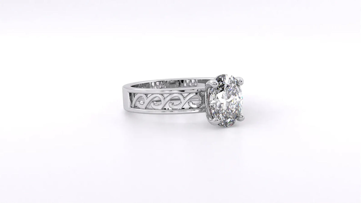 Side angle view of a 2 CT oval lab grown diamond engagement ring showing wave filigree shank in white gold.