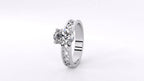Angled top perspective view of white gold 2 carat oval diamond ring with intricate openwork filigree band.