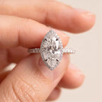 Close-up view of 3 Carat Marquise Cut Lab Grown Diamond Halo Ring held between fingers displaying diamond scale