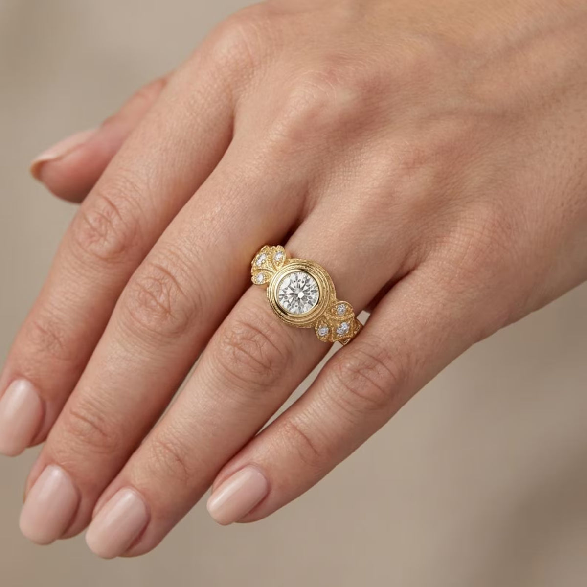 Model hand wearing 2 carat round lab grown diamond ring with leaf accent shoulders