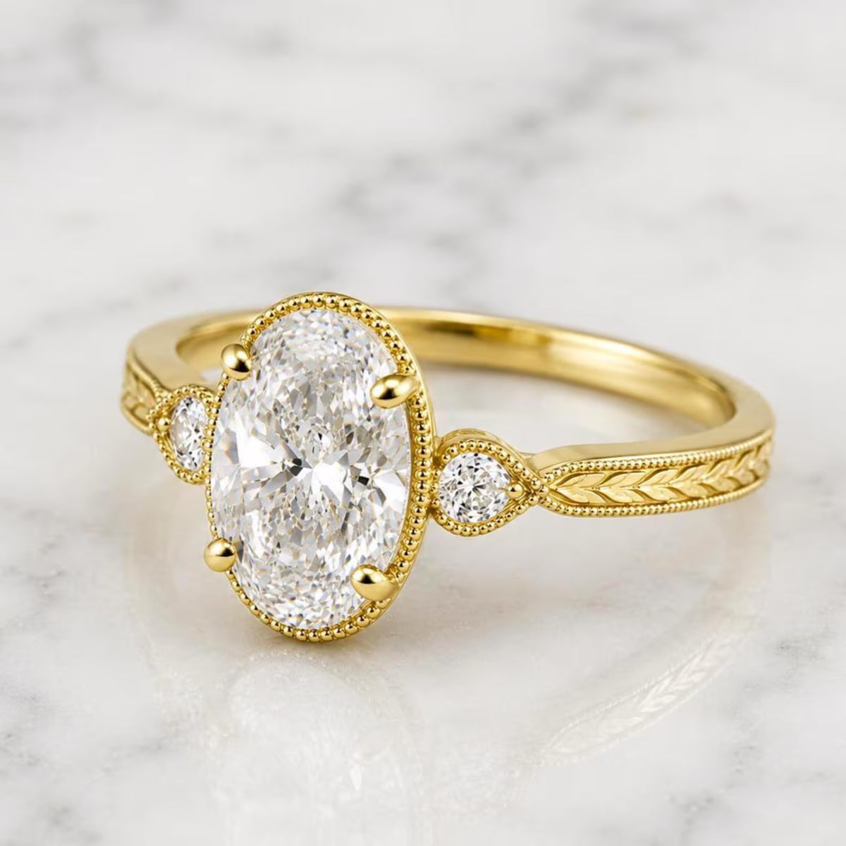 Angled perspective view of 2 Carat Oval Cut Lab Grown Diamond Vintage Ring with milgrain bezel frame and engraved wheat band in yellow gold