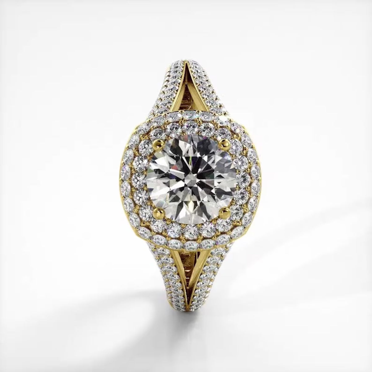 Top-down vertical view of 3 carat round lab grown diamond ring with double halo yellow gold split shank.