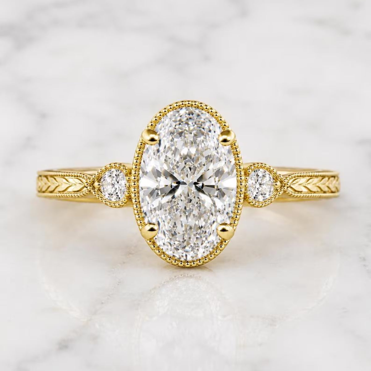Top-down view of 2 Carat Oval Cut Lab Grown Diamond Engagement Ring showing milgrain trim, side accents, and chevron engraved band