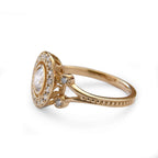 Side profile view of a 2 CT round lab grown diamond engagement ring in 14K yellow gold showing milgrain split shank and filigree gallery detail.