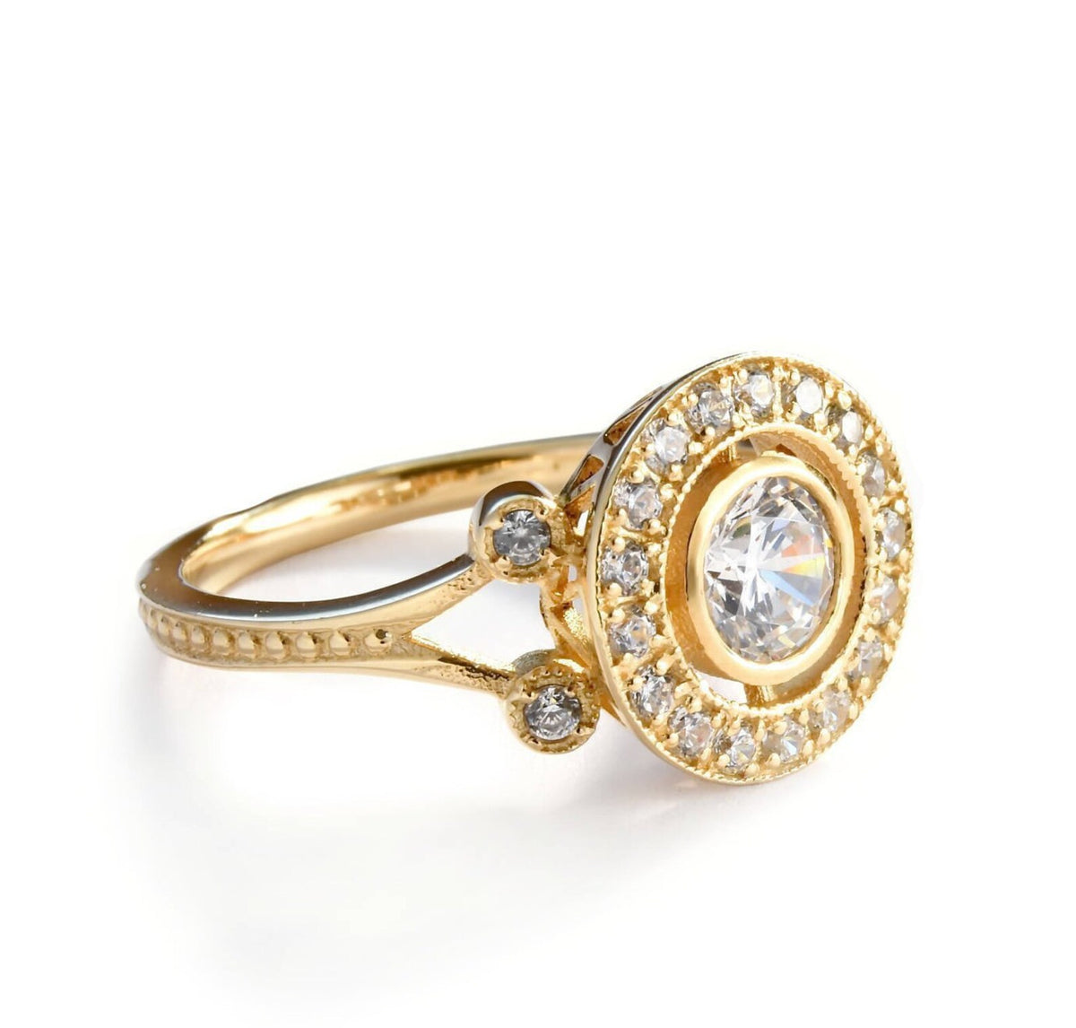 Three-quarter angle of a yellow gold 2 CT round lab created diamond target halo engagement ring highlighting bezel side accent stones.