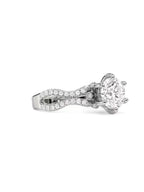 Angled perspective of a 2ct round lab diamond ring showing the hidden bezel surprise diamond in the basket.