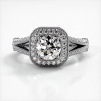 Top-down view of white gold engagement ring featuring a 2 CT round lab grown diamond framed by a milgrain cushion halo.