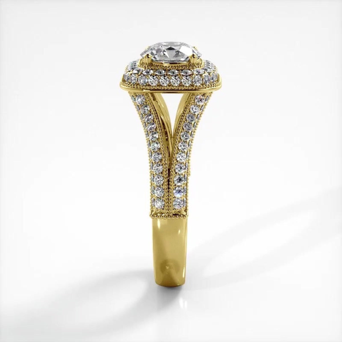 Side view of 14K yellow gold 2 CT round lab diamond ring displaying split-shank structure and pavé setting.
