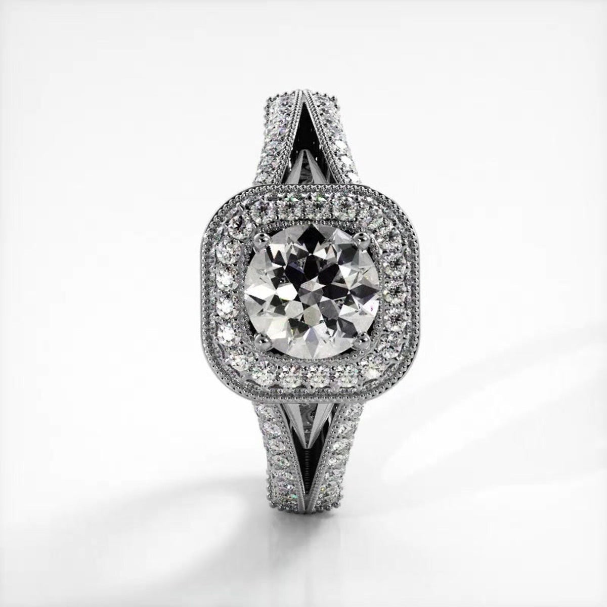 Vertical top view of white gold 2 carat round lab created diamond engagement ring with split shank.