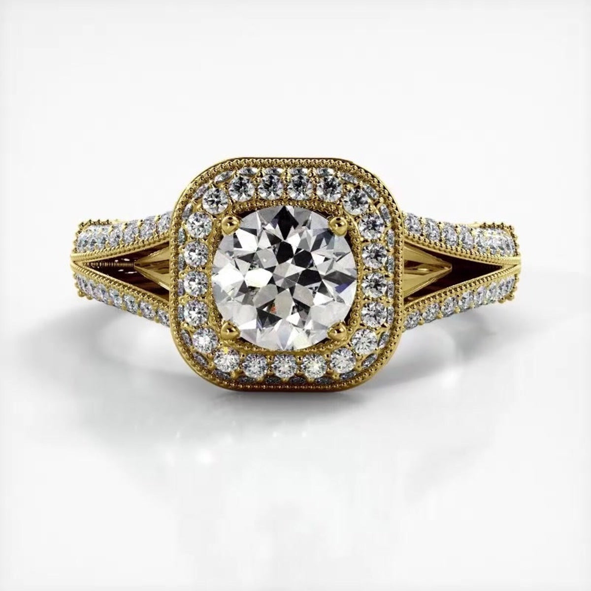 Top-down horizontal view of yellow gold 2 CT round lab diamond engagement ring with cushion-shaped milgrain halo.