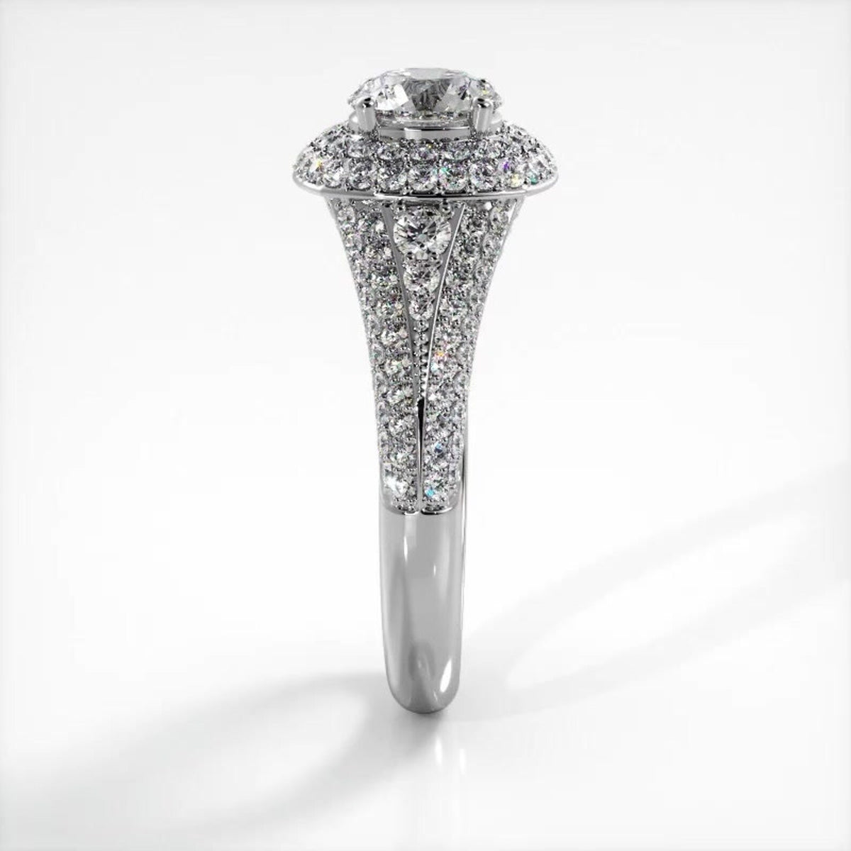 Side elevation view of a 2 carat round lab diamond engagement ring in white gold with multi-row pave shank.