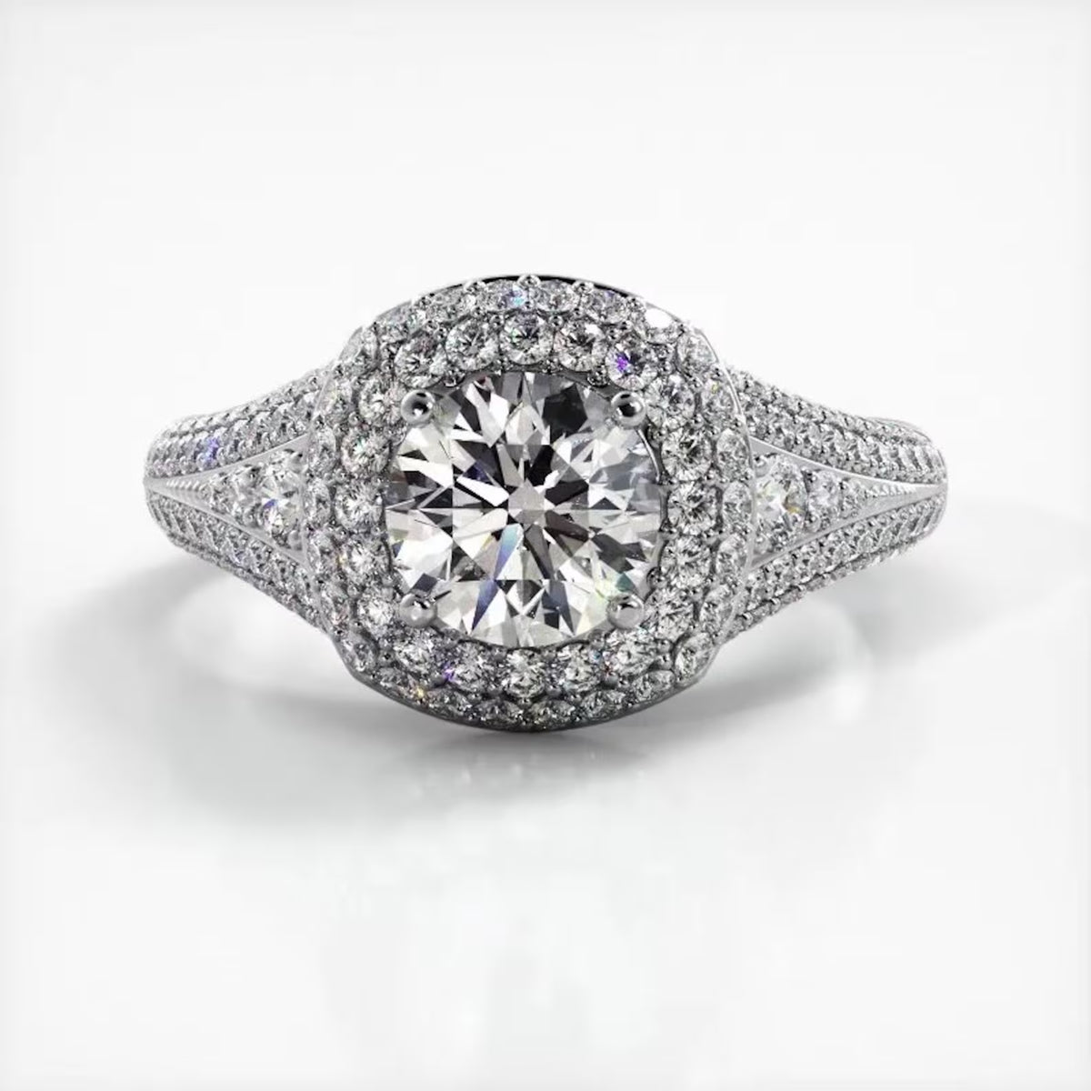 Top-down view of a white gold engagement ring featuring a 2 CT round lab diamond with double cushion halo.