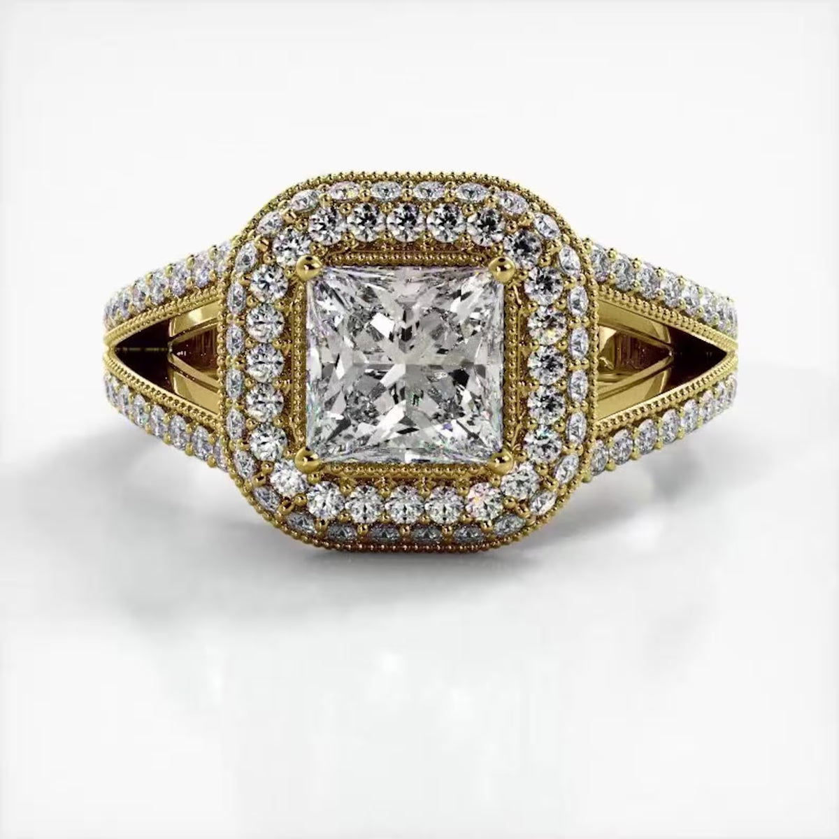 Top-down view of a 2 CT princess cut lab grown diamond engagement ring in 14K yellow gold with a double halo and milgrain details.
