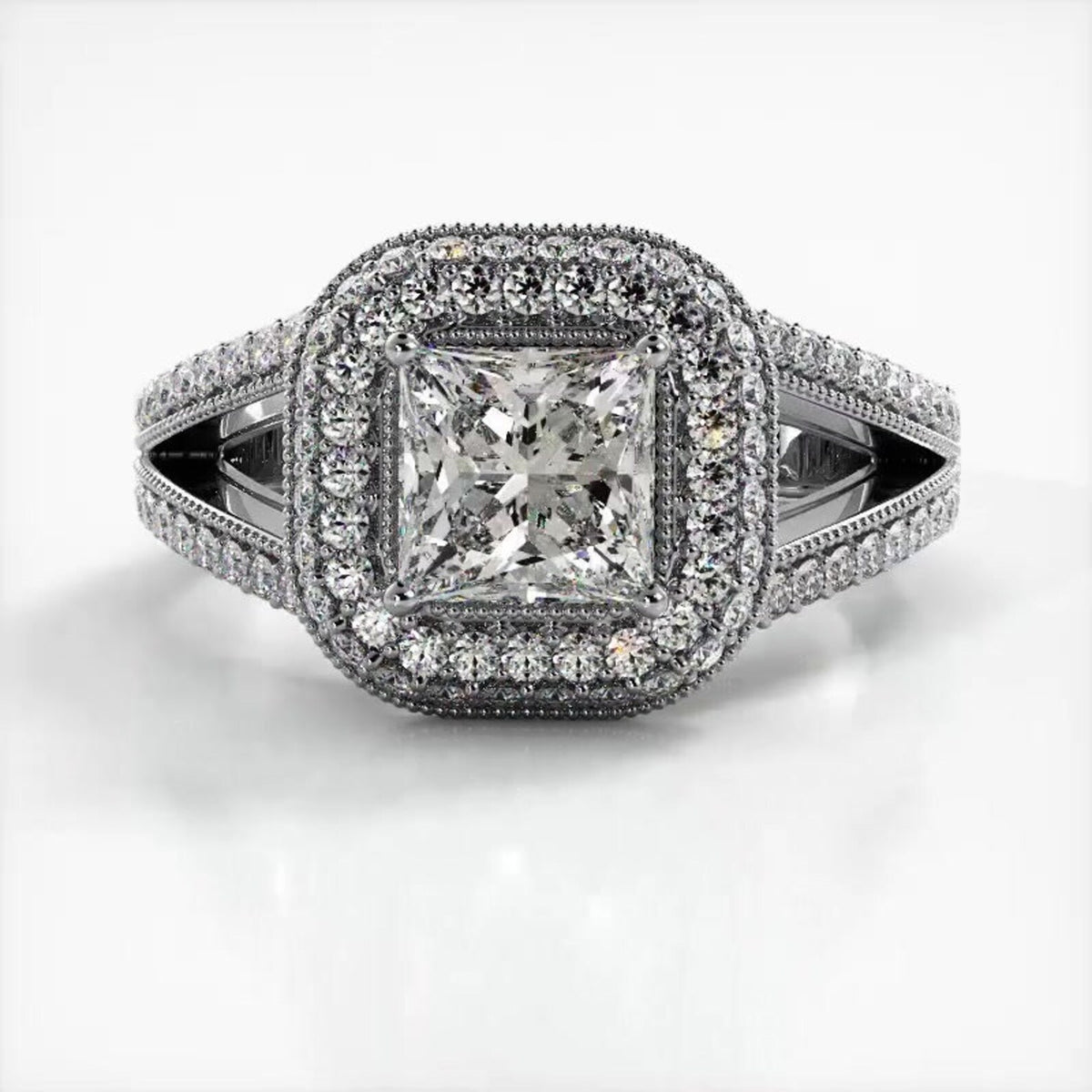 Top view of a white gold engagement ring featuring a 2 CT princess cut lab diamond surrounded by a double milgrain halo.