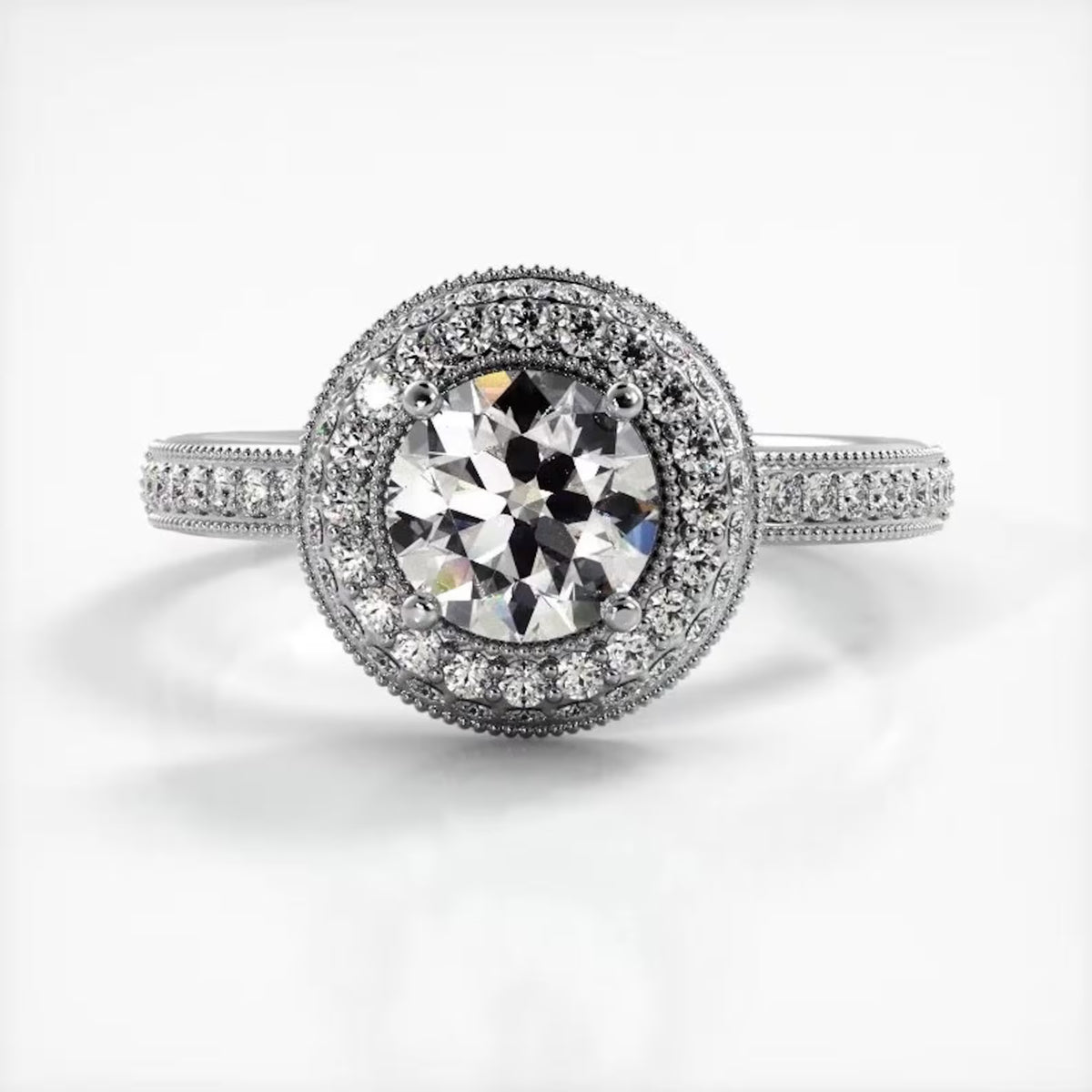 Top-down view of a 2 CT round lab grown diamond engagement ring in white gold with double milgrain halo.