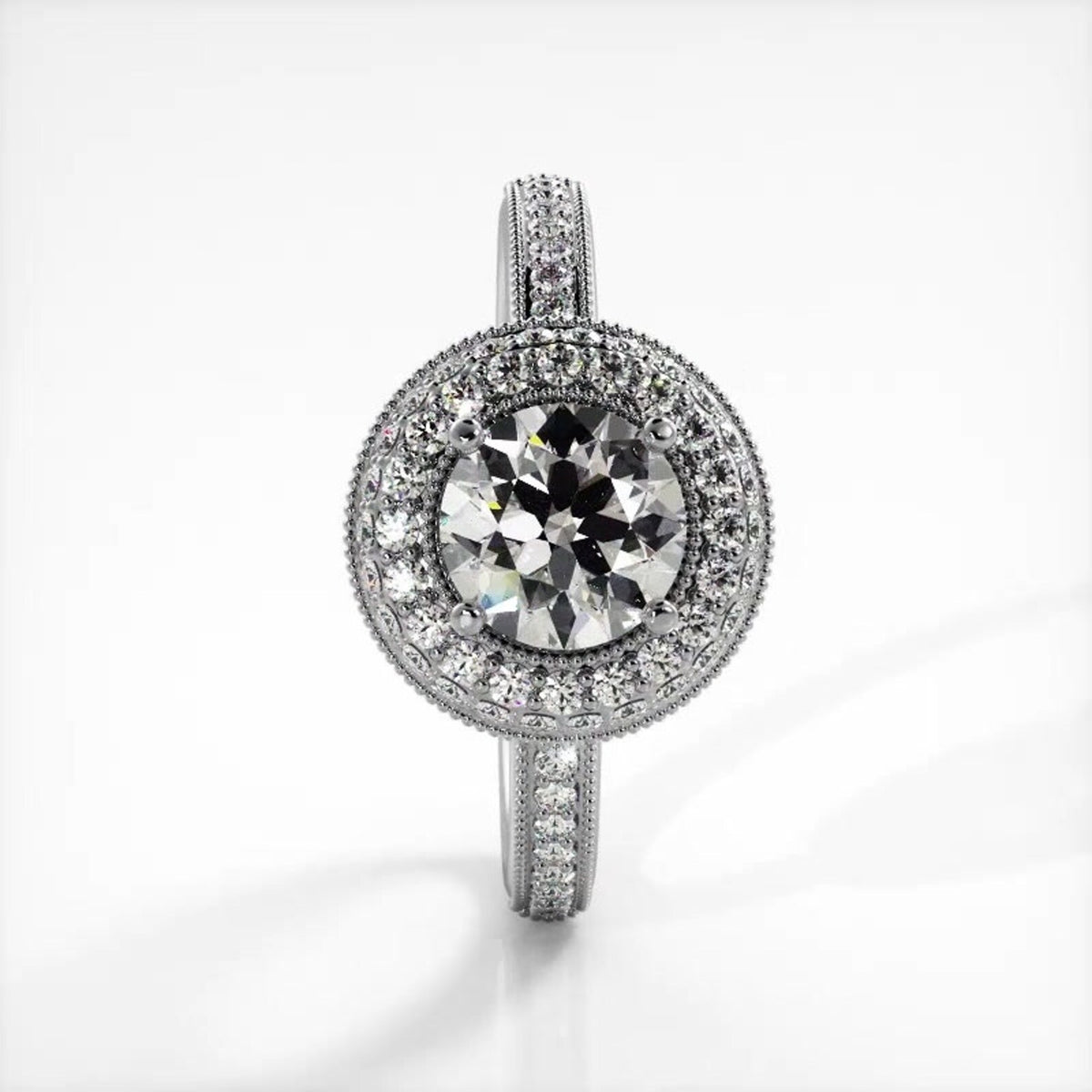 Vertical top view of a white gold 2 CT round lab diamond ring featuring double halo with pave band.