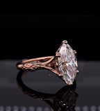 Three-quarter perspective of a 4 CT marquise cut lab grown diamond engagement ring in rose gold with carved vintage band details.