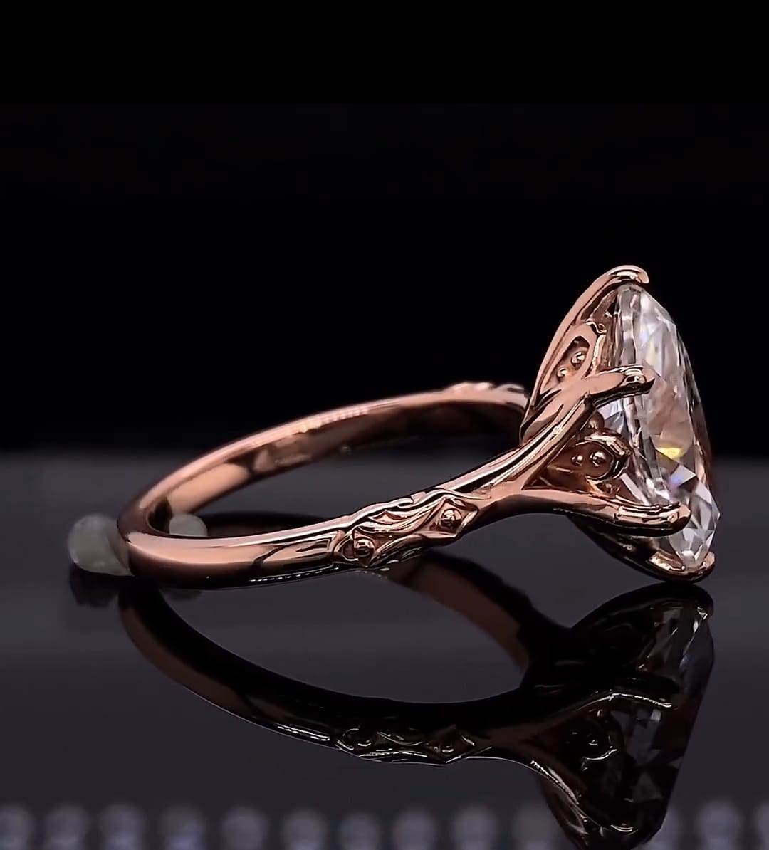 Side profile view highlighting the ornate carved gallery and 6-prong setting of a 4 CT marquise lab diamond rose gold ring.
