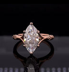 Front-facing view showing a 4 carat marquise cut lab grown diamond solitaire ring in rose gold with split cathedral shoulders.