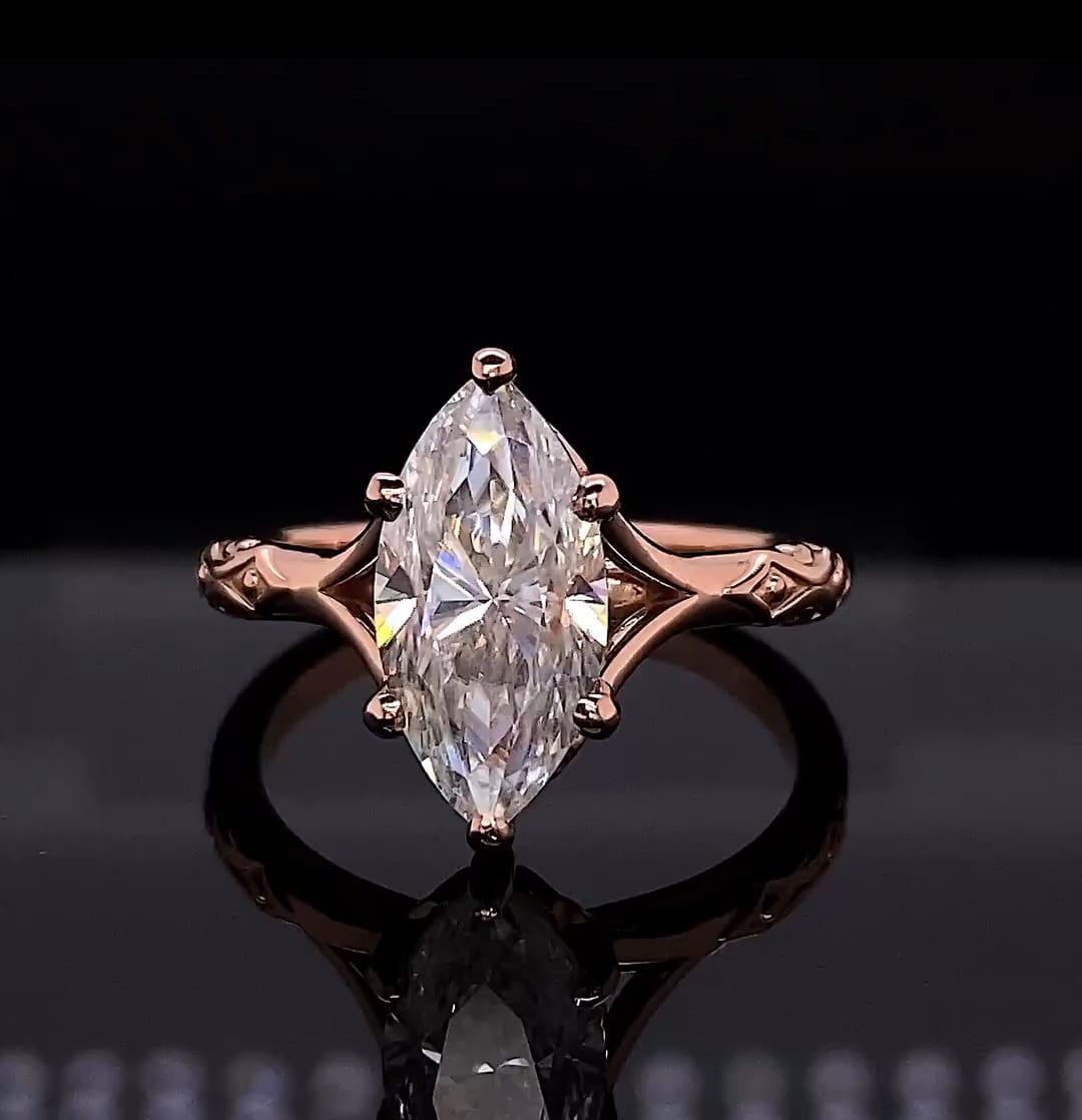 Front-facing view showing a 4 carat marquise cut lab grown diamond solitaire ring in rose gold with split cathedral shoulders.