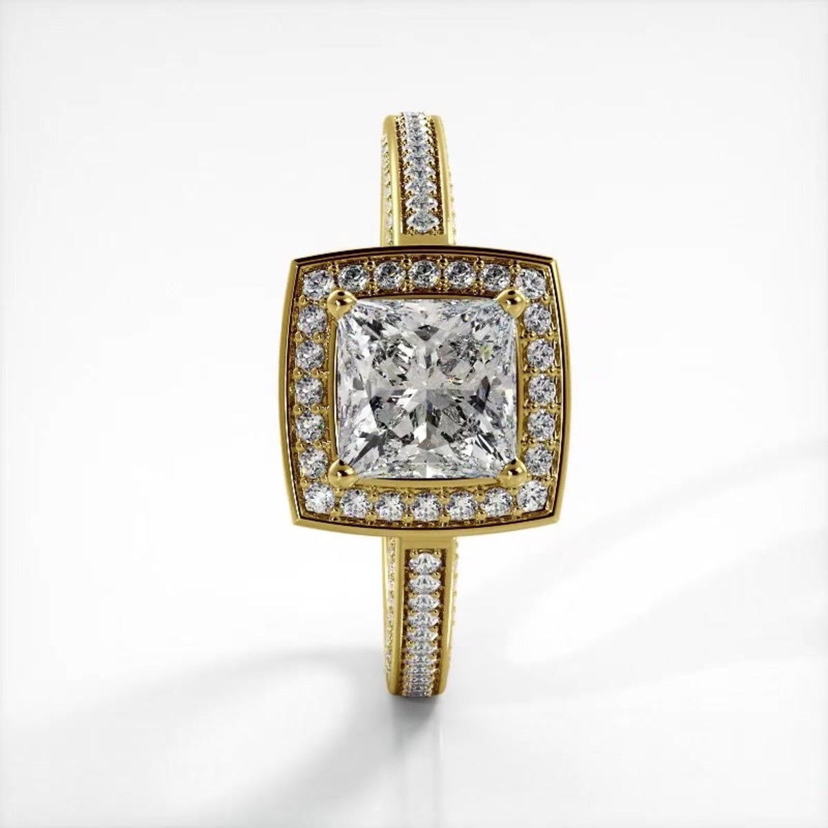 Vertical top view of a 2 CT princess cut lab grown diamond ring with cushion halo in yellow gold.