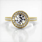 Top-down view of a 3 CT round cut lab grown diamond engagement ring in yellow gold with round milgrain halo and pave band.