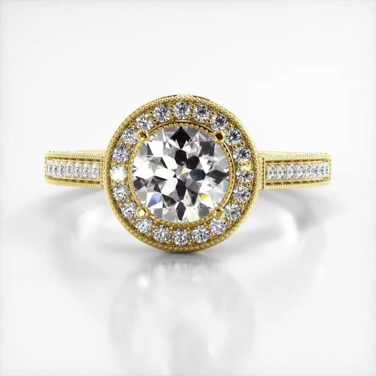 Top-down view of a 3 CT round cut lab grown diamond engagement ring in yellow gold with round milgrain halo and pave band.