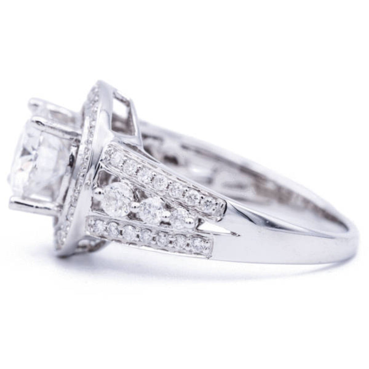 Profile view of 3 carat round lab diamond halo ring displaying prong setting and graduated side diamond accents