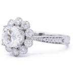 Three-quarter side view of 3 CT round lab grown diamond engagement ring with floral scalloped halo and paved shank