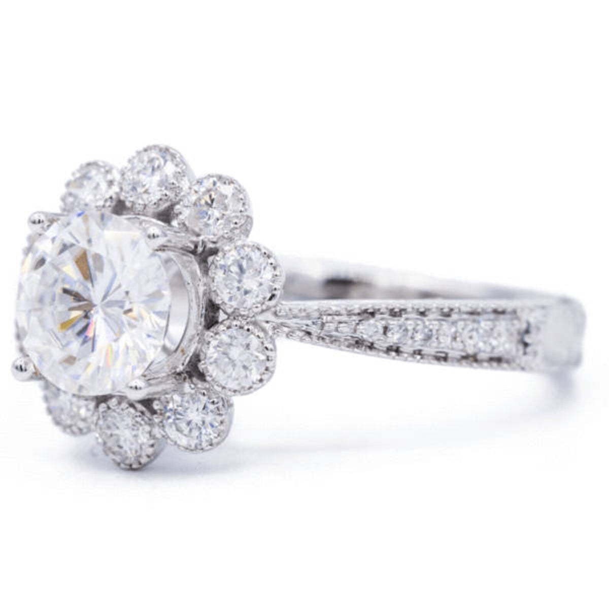 Three-quarter side view of 3 CT round lab grown diamond engagement ring with floral scalloped halo and paved shank