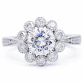Top-down view of 3 carat round brilliant lab diamond in a flower bloom scalloped halo setting