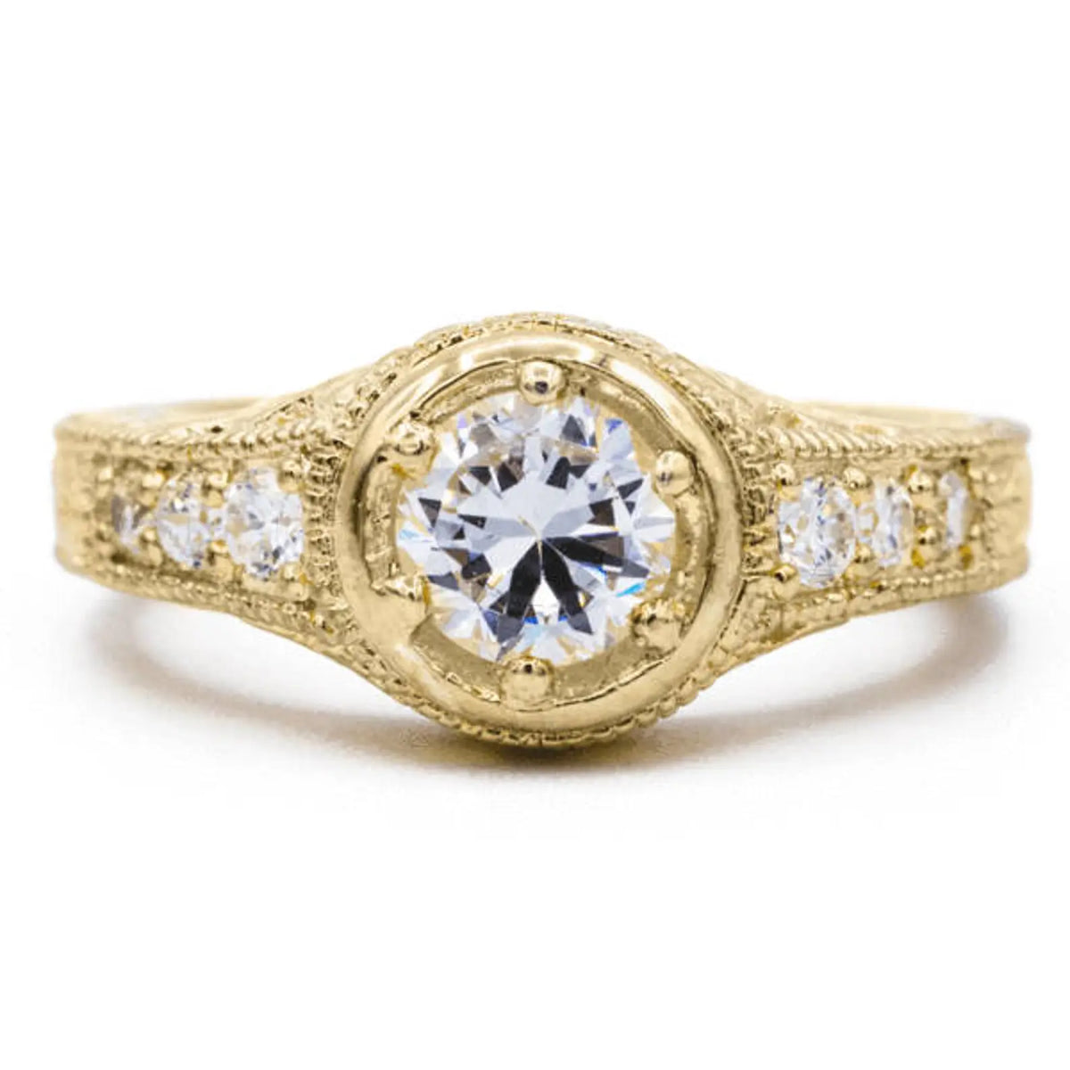 Front view of 2 CT round lab grown diamond ring in yellow gold with hand-engraved leaf shank and side accent diamonds