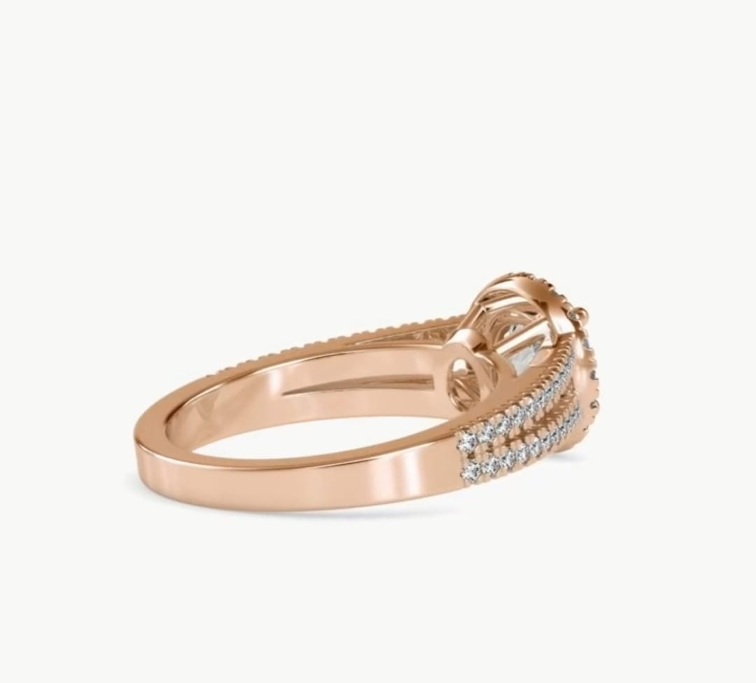 Side view of a rose gold 2 carat round lab grown diamond engagement ring with a split shank pave band.