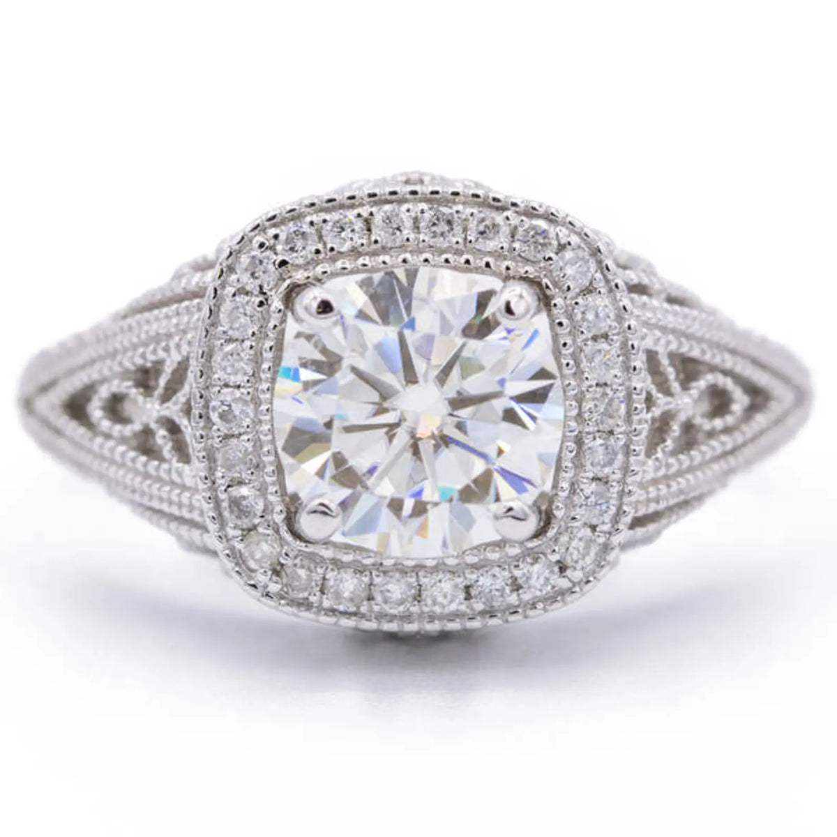Top view of 2 CT cushion cut lab grown diamond ring with milgrain cushion halo and filigree shoulders