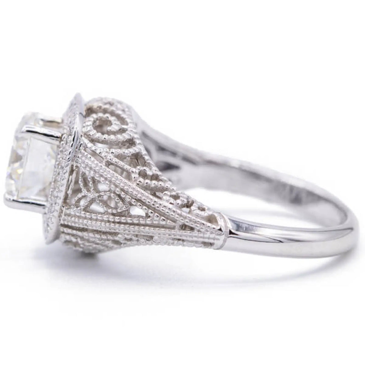 Side profile of vintage 2 carat cushion lab diamond engagement ring showing cathedral setting and filigree shank