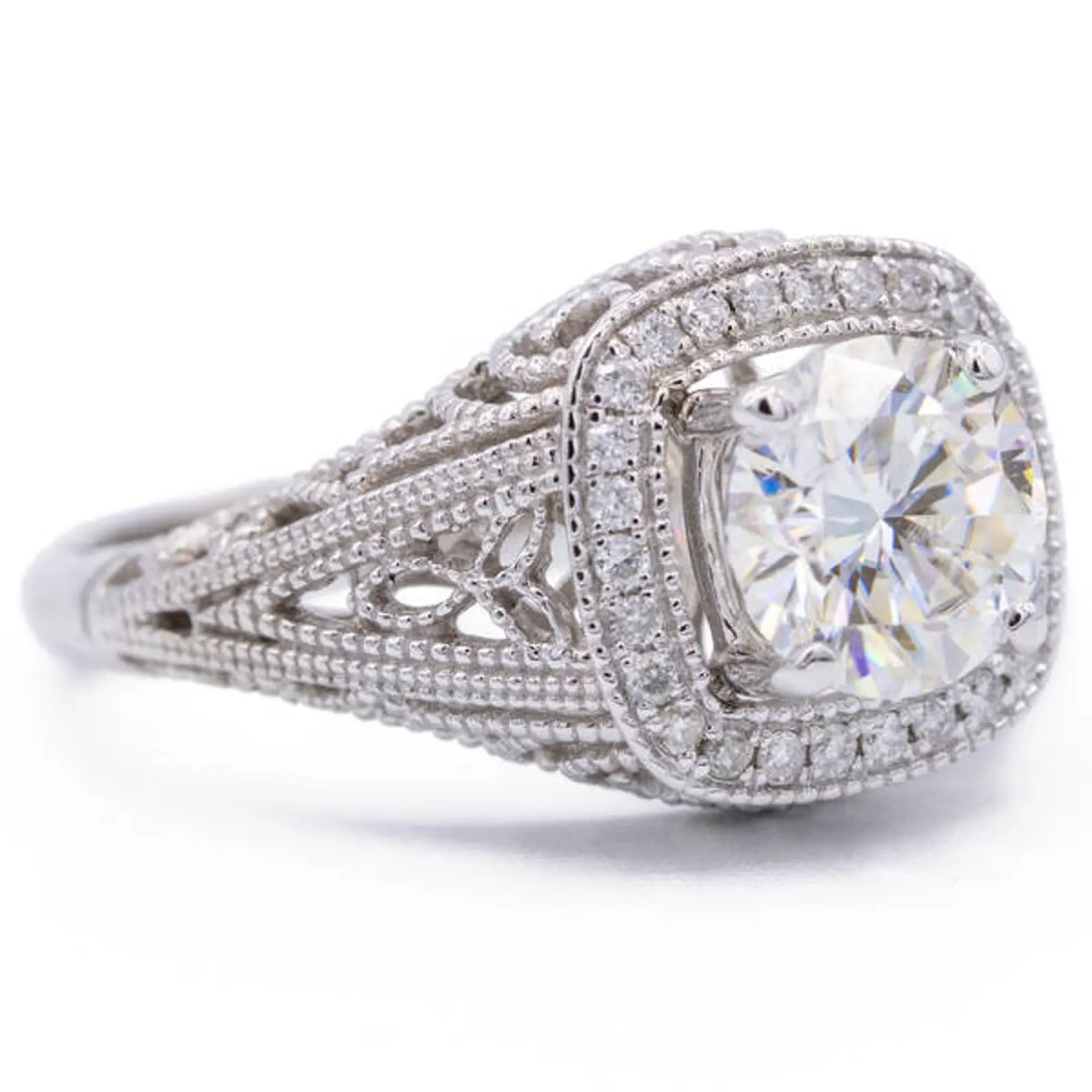 High-angle view of 2 CT cushion cut lab created diamond with pave cushion halo border
