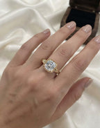 Perspective on-hand photo of 3 carat Asscher lab diamond ring showing step cut facets and engraved yellow gold band