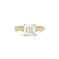 Front view of 2 CT Asscher cut lab created diamond engagement ring in yellow gold with hand-engraved shoulders