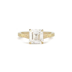 Front view of 2 CT Asscher cut lab created diamond engagement ring in yellow gold with hand-engraved shoulders