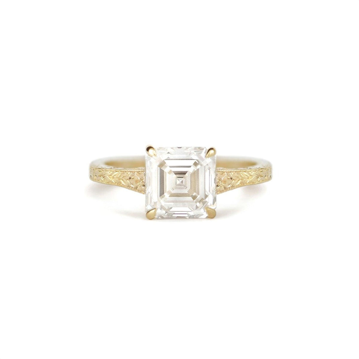 Front view of 2 CT Asscher cut lab created diamond engagement ring in yellow gold with hand-engraved shoulders
