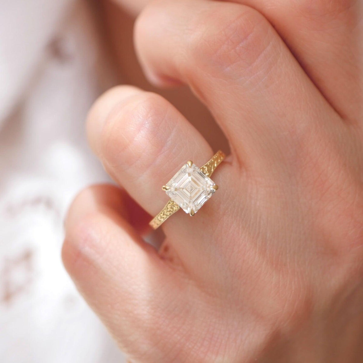 On-hand close-up showing top facet symmetry of 2 carat Asscher lab grown diamond ring