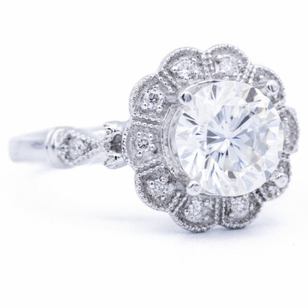 Side profile view of 3 CT round cut lab grown diamond vintage scalloped halo ring showing filigree cathedral gallery
