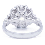 Underside view of 3 CT round lab diamond vintage halo setting displaying openwork basket and white gold band