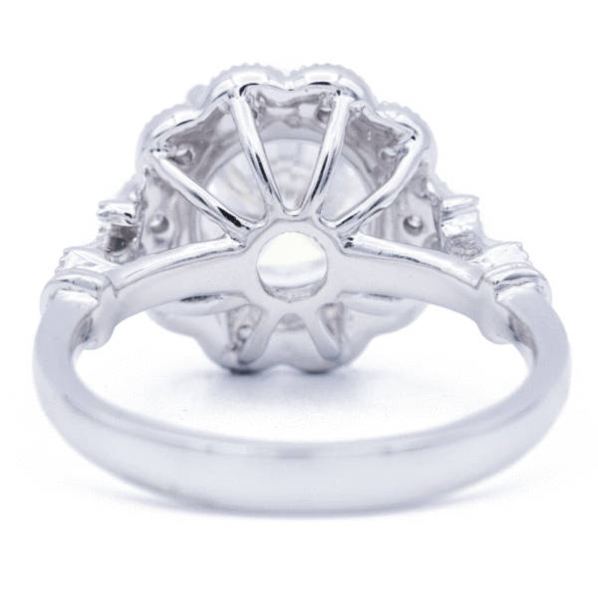 Underside view of 3 CT round lab diamond vintage halo setting displaying openwork basket and white gold band